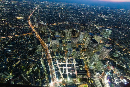 新宿の高層ビル群を夜景で空撮した都市風景