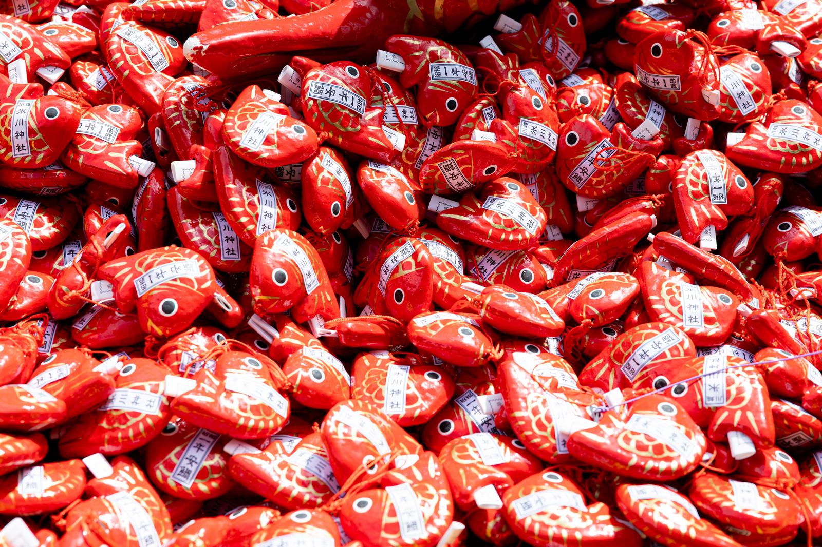 Pile of sea bream omikuji fortune slips at Hikawa Shrine