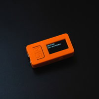 オレンジ色のIoT開発基板M5Stackの操作の写真