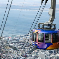 ケープタウンのテーブルマウンテンを上る赤いロープウェイの写真