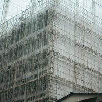高層ビルも竹の足場で囲む香港の建設現場で働く作業員たちの写真