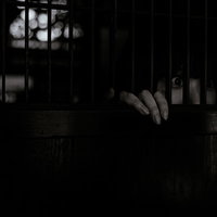 暗闇で格子戸越しに惨劇を目撃する女性の恐怖の瞬間の写真