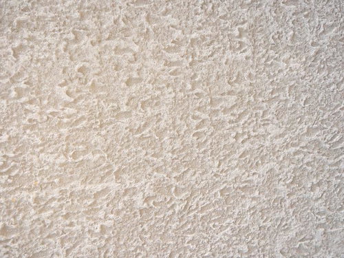 マンションの白い吹付け仕上げの荒いテクスチャー壁