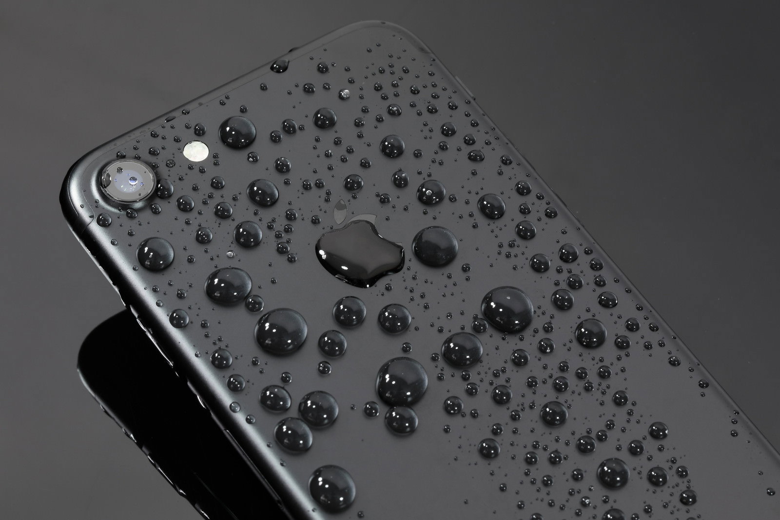 水滴が全面に付いた黒いiPhoneの背面
