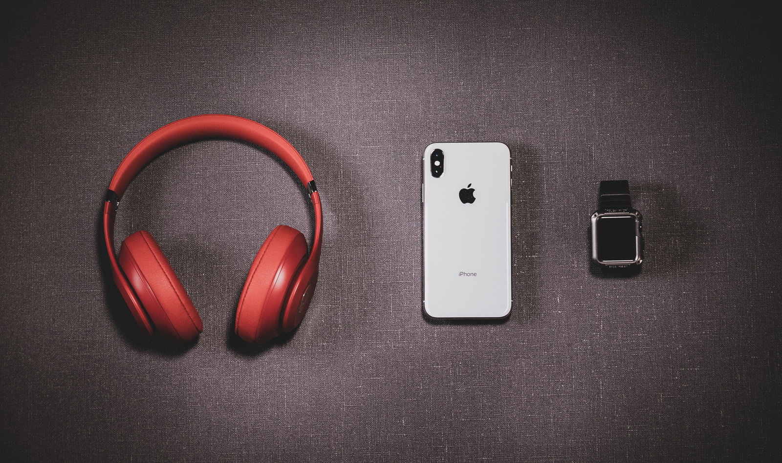 赤いヘッドフォン、iPhone X、Apple Watchを