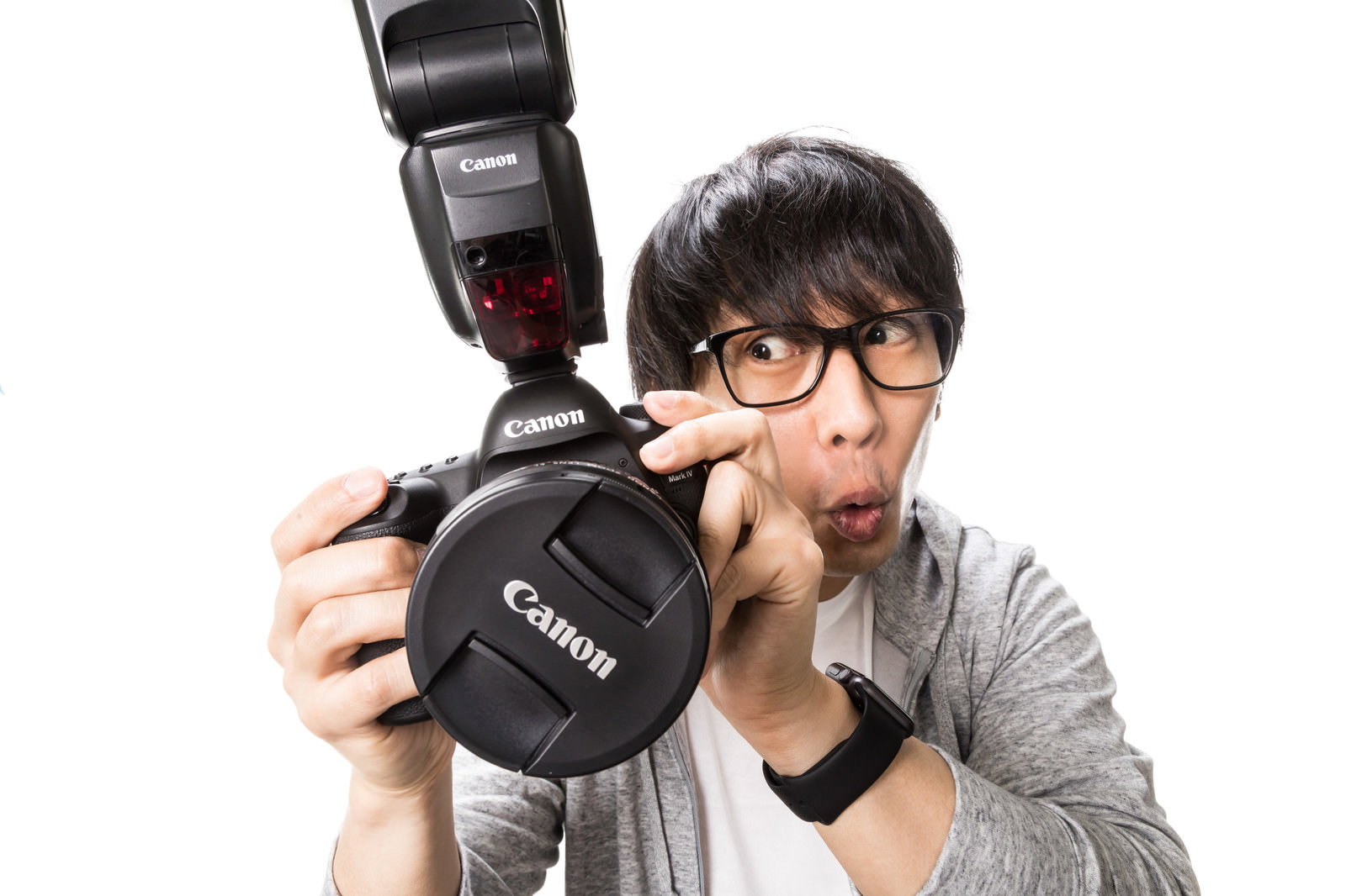 一眼レフカメラとストロボを持ち撮影データを確認する興奮したカメコの男性［モデル：大川竜弥］