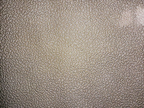 ベージュから茶色にグラデーションする珊瑚模様の壁のテクスチャー