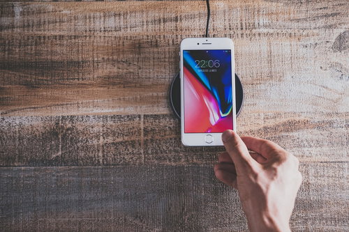 iPhone 8 をワイヤレス充電パッドにかざす