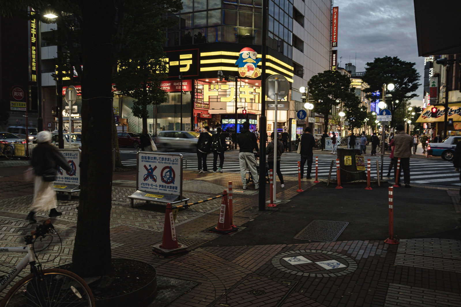夜の伊勢佐木長者町でドンキホーテ前の横断歩道を渡る人々