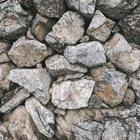 隙間にはめ込んだ石のテクスチャと石積みの表面の写真