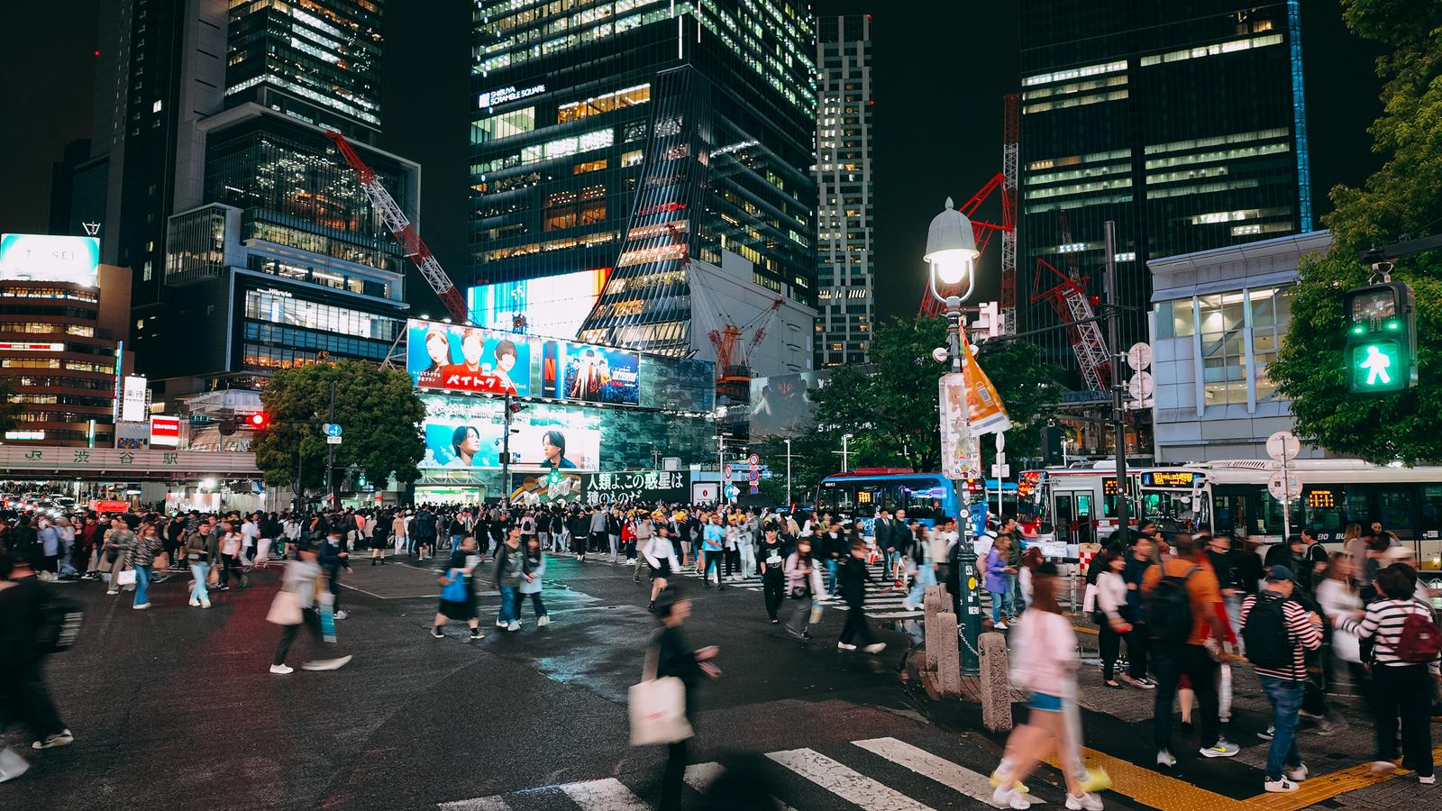 夜間に大勢の人が行き交う渋谷スクランブル交差点とビル群