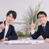 資料を前にナンバーワンを示す会社員のビジネスミーティングの写真