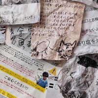 散らばった手書きメモと古い新聞紙の写真