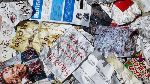 床に散乱したしわくちゃの手書きメモと書類