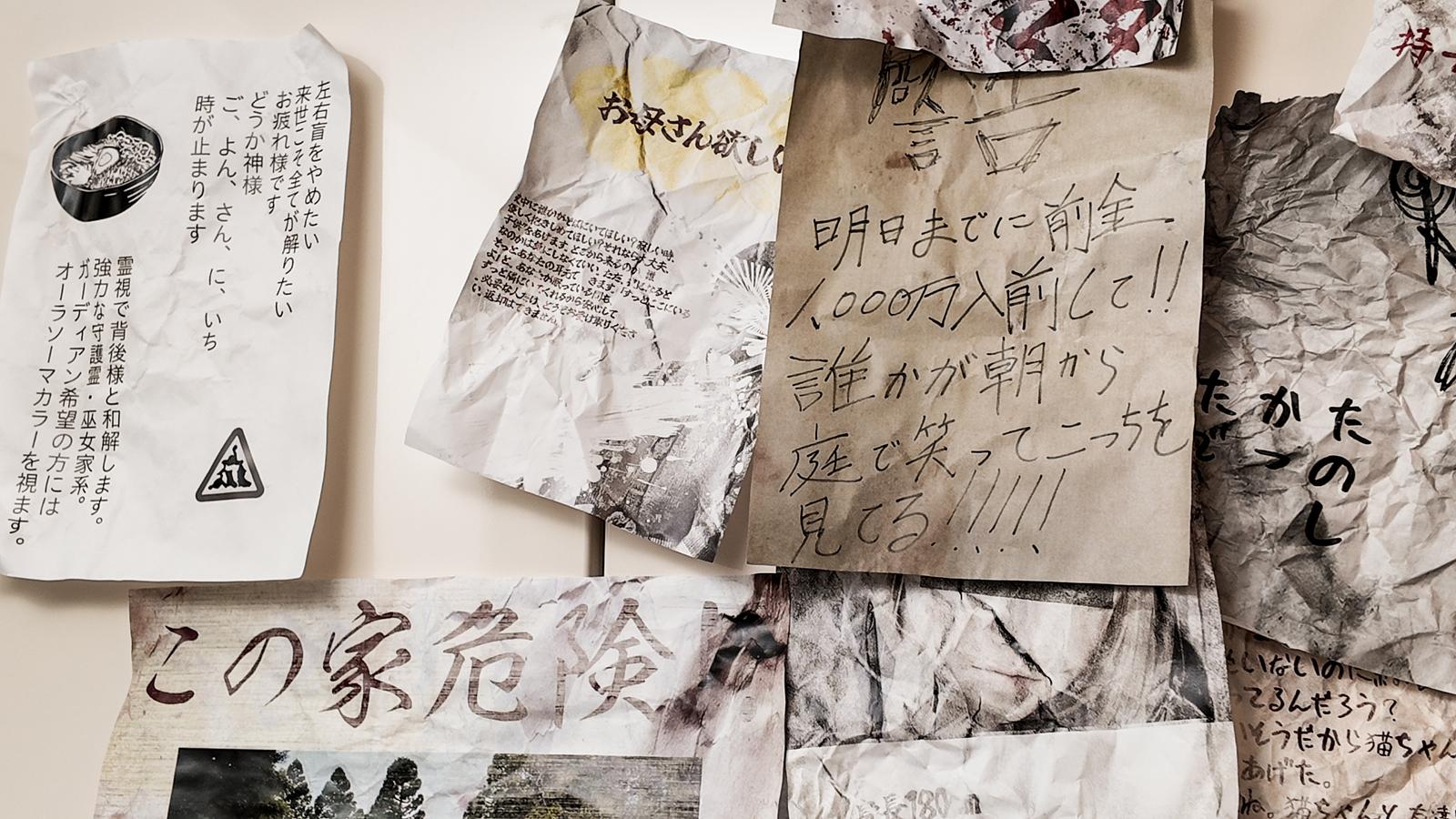 Handwritten notes and aged papers scattered across a surface