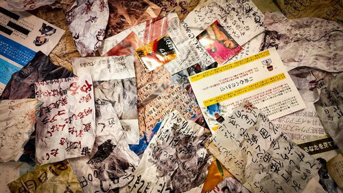 床一面に散乱する手書きの怪文書と紙くず