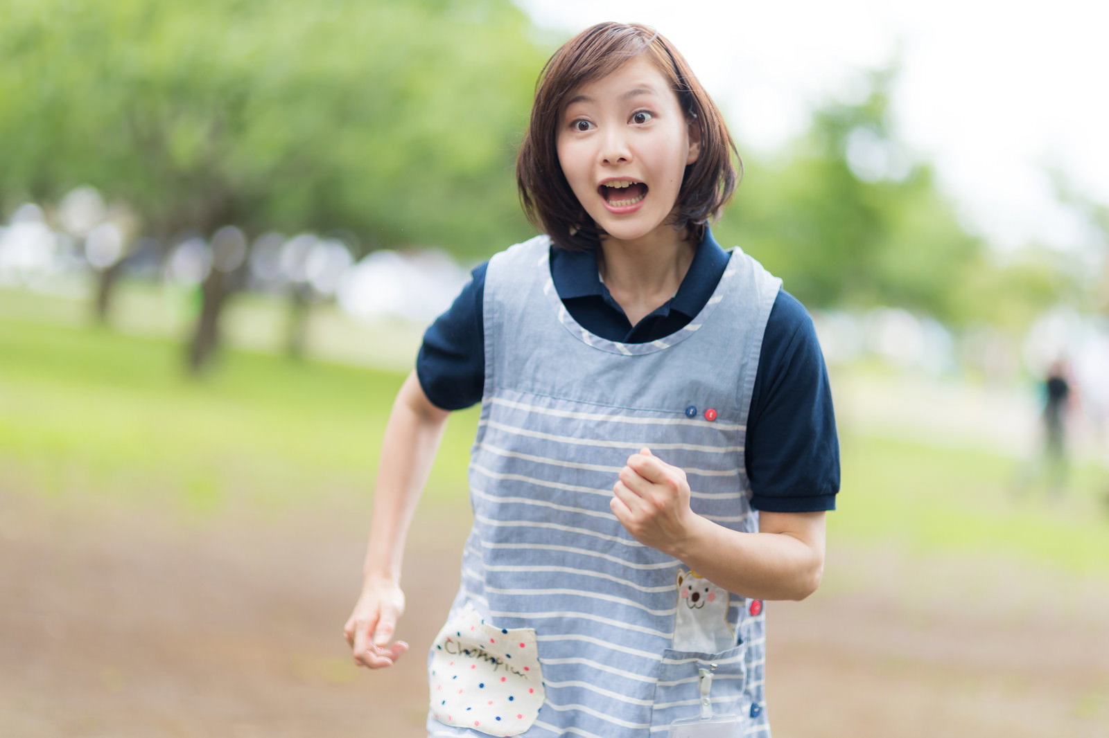 エプロン姿で大慌てでダッシュする女性介護士［モデル：yumiko］