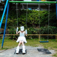 公園のブランコに座るジューンブランコの花嫁の写真