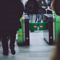 駅の改札を通る会社員たちの足元・朝の通勤ラッシュの写真