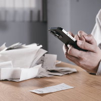 スマホで山になった領収書を読み取る確定申告の写真