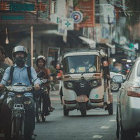 カンボジアの市街地を行き交うバイクとトゥクトゥクの写真