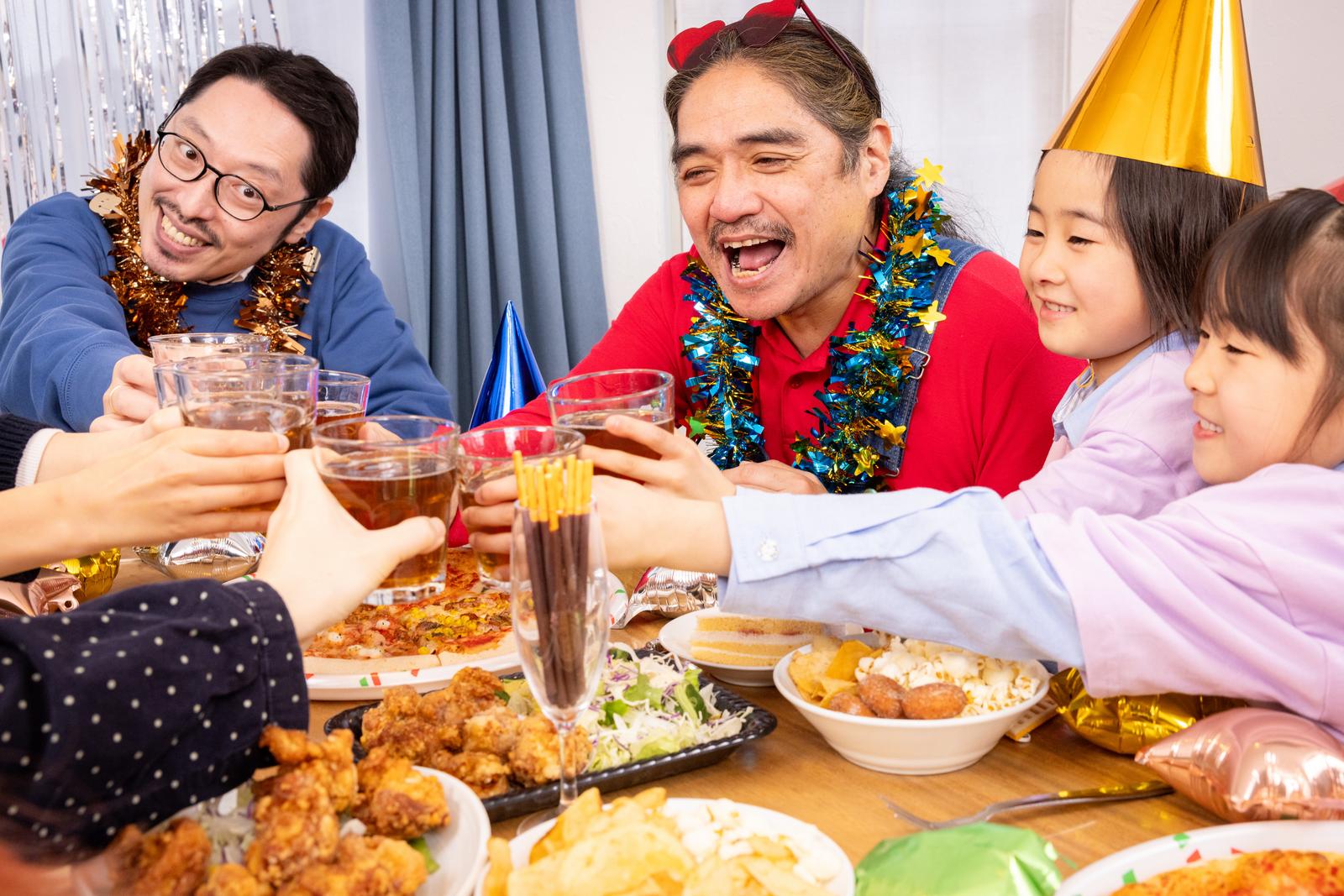 A family scene of people raising their glasses to toast