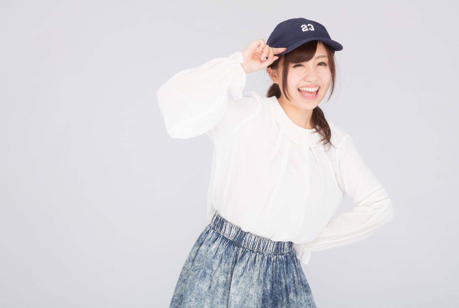 紺色キャップをかぶって笑顔の女子大生［モデル：河村友歌］