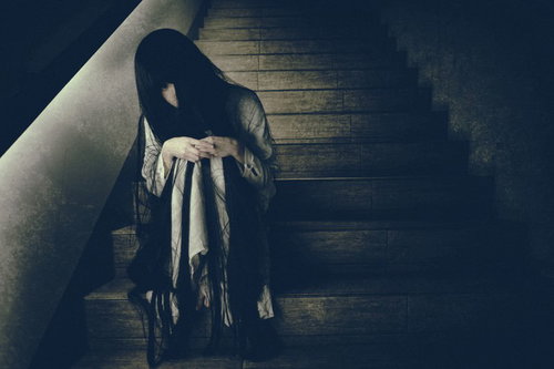 終電を逃した薄暗い階段で俯く不気味な女性