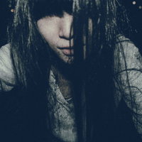 痛んだ長い黒髪で顔を覆う女性の幽霊の写真