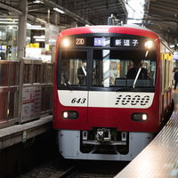 ホームに滑り込む赤い京急電車（京急逗子線）の写真