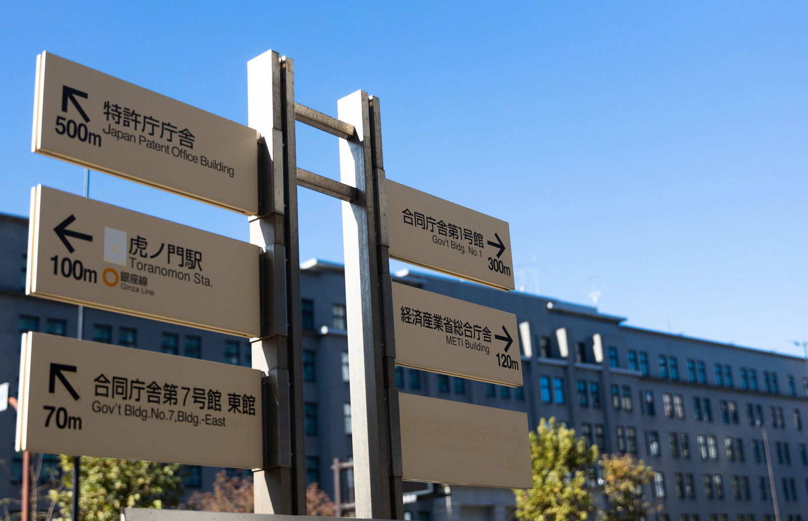 青空を背景にした国税庁前の木製指導標識と案内板