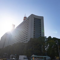 青空を背景に太陽光で照らされた警視庁本部庁舎の写真