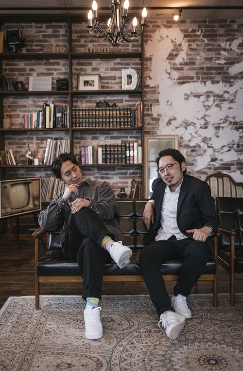 ソファーで依頼の話をする探偵と相談者の二人