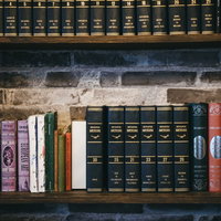 本棚に整頓された洋書と百科事典、色彩豊かな書籍コレクションの写真