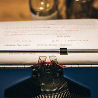 タイプライターに印字された文字列と機械部分の写真