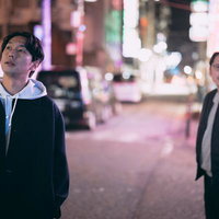 夜の街で尾行調査をする探偵二人組の追跡と監視の写真
