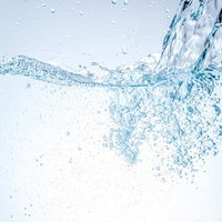 勢いよく溜まるクリアなミネラルウォーターの泡立ちの写真