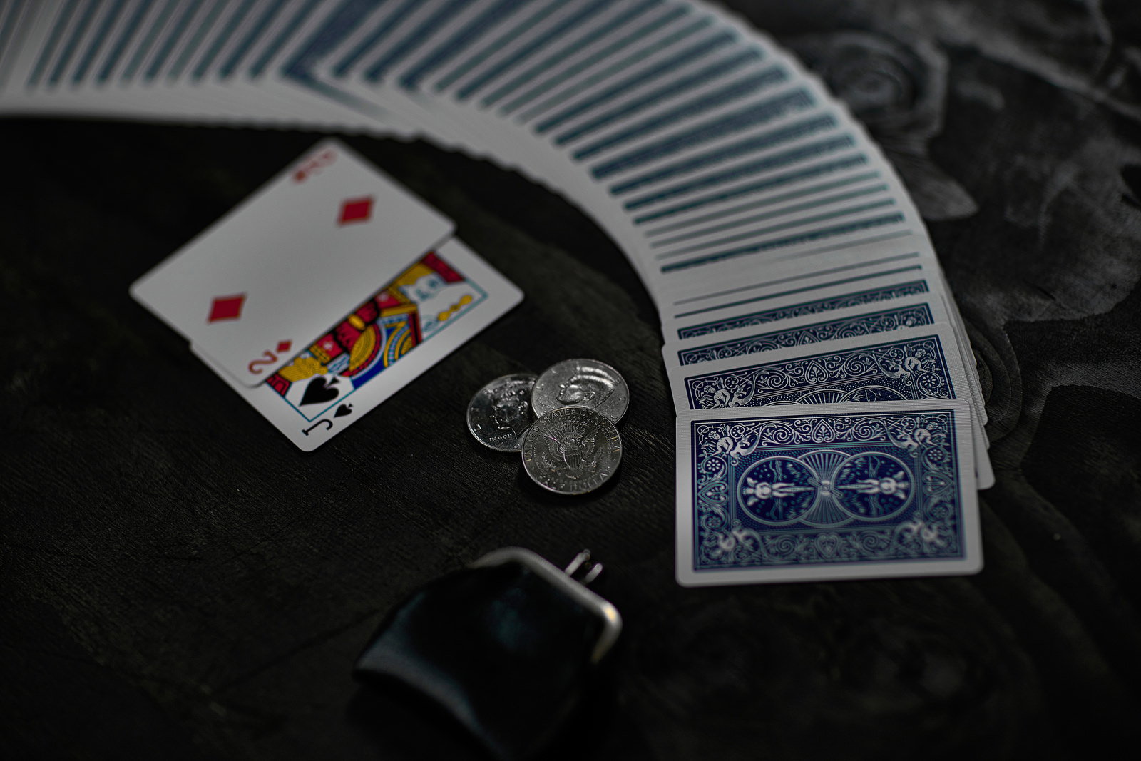 Playing Cards Spread with Coins on Dark Table — Free Stock Photo - PAKUTASO