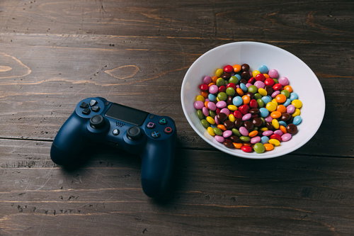 ゲームコントローラーとカラフルなマーブルチョコの組み合わせ