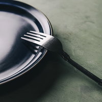 黒いフォークと白い皿のディナーセッティングの写真