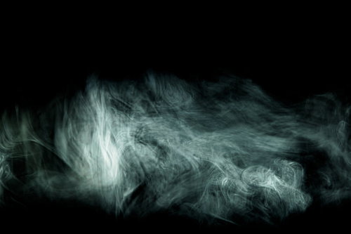 黒い背景に立ち込める流れ出る不穏なガスと煙