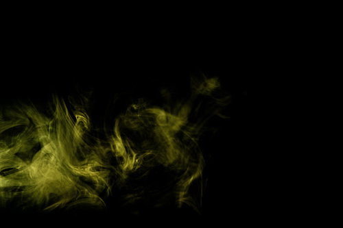 黄色く光るスモークが立ち上がる煙の抽象背景