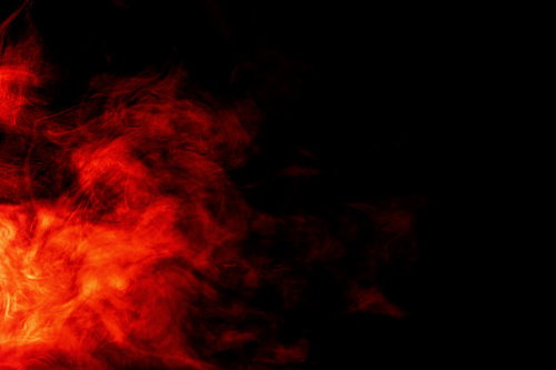 赤とオレンジに輝く燃え盛る炎とスモークの背景