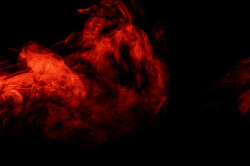 黒い背景に立ち上がる赤いスモークと炎のエフェクト