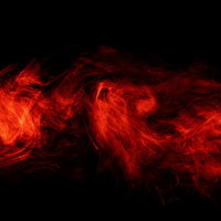 呪われてそうな赤とオレンジの炎と煙が立ち上るの写真