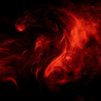 暗闇に立ち上がる呪力ぽいオーラ 赤い煙のスモークの写真