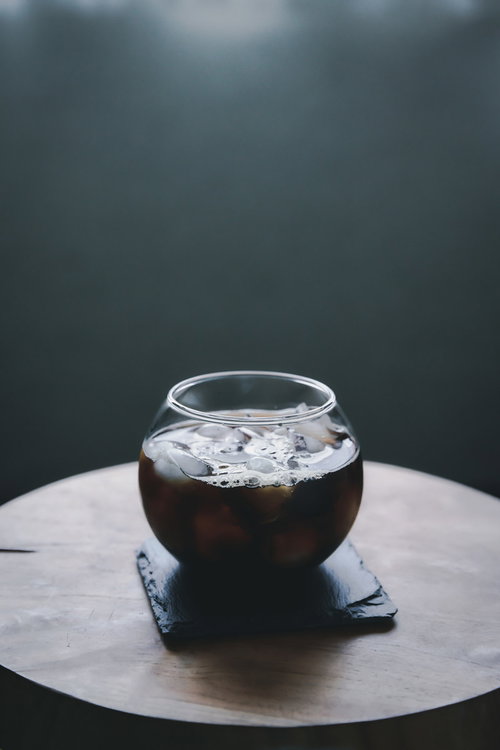 グラスに注がれたアイスコーヒーの表面に泡立つ泡