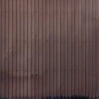 縦の波状模様が入った茶色のトタン外壁の写真