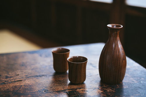 木目のテーブルに置いた徳利とお猪口の日本酒セット