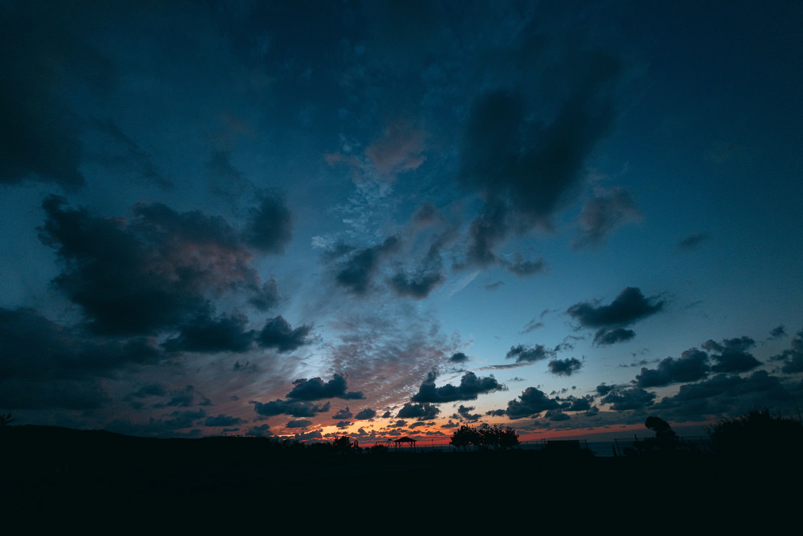 夕焼け空の下に広がる神津島のよたね広場の風景